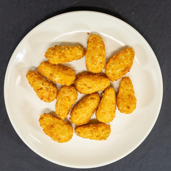 A white plate filled with golden-brown, breaded fried cheese curds on a dark background.