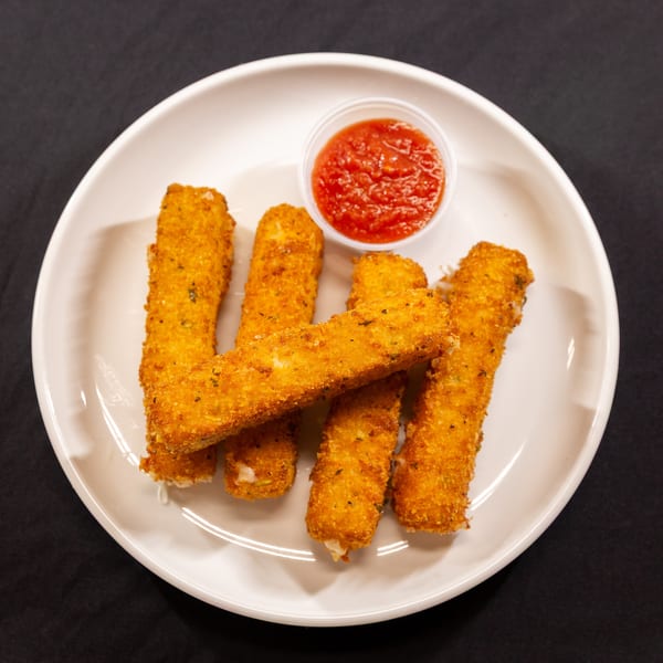 Golden-brown mozzarella sticks with a side of red marinara sauce on a white plate.